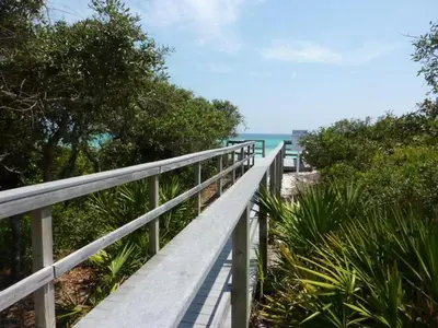 a wooden boardwalk leading down to the beach at Legacy 505- Pearl by the Sea in Santa Rosa Beach