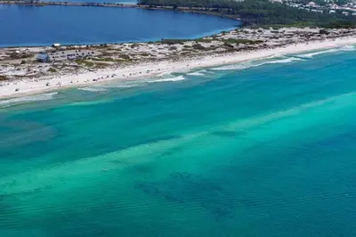 an aerial view of a beach with people in the water at Legacy 505- Pearl by the Sea in Santa Rosa Beach