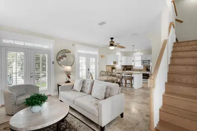a living room with a couch and a table at Sunset Serenade in Rosemary Beach