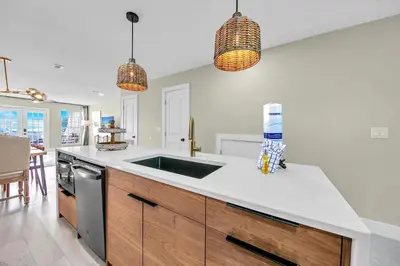 a kitchen with a sink and a stove at Modern Beach Bungalow in Panama City Beach