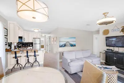 a living room with a couch and a kitchen at Beachwood Villas 12C in Santa Rosa Beach