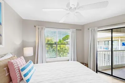 a bedroom with a bed and a large window at Beachwood Villas 12C in Santa Rosa Beach
