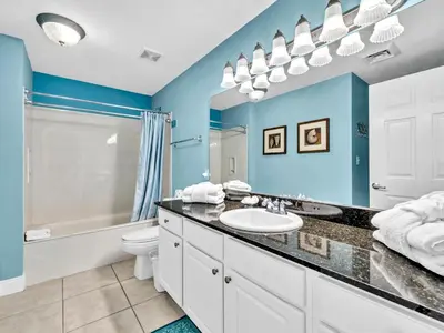 a bathroom with a sink and a tub and a toilet at Calypso 1-2109 East in Panama City Beach