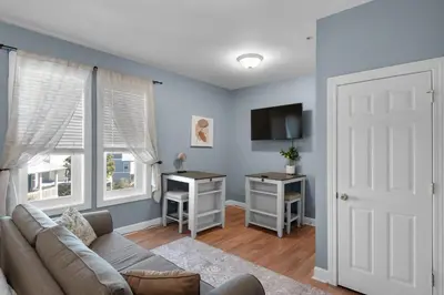 a living room with a couch and a tv and a door at Village of South Walton B375 in Seacrest