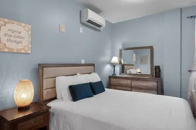 a bedroom with a white bed and a mirror at Village of South Walton B375 in Seacrest