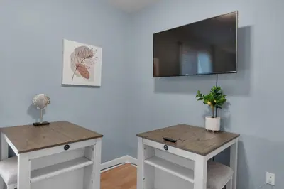 a room with two tables and a flat screen tv at Village of South Walton B375 in Seacrest