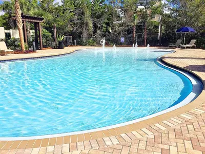 a large swimming pool with blue water at Village of South Walton B375 in Seacrest