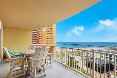 a balcony with a table and chairs and a view of the beach at Calypso 3-807 in Panama City Beach