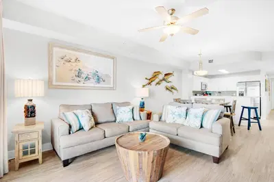 a living room with a couch and a table at Calypso 3-807 in Panama City Beach