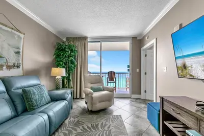 a living room with a couch and a chair at Majestic Beach Towers 2-1005 in Panama City Beach