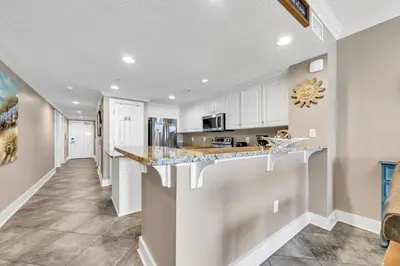 a kitchen with white cabinets and a counter top at Majestic Beach Towers 2-1005 in Panama City Beach