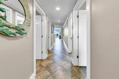 a hallway of a home with a mirror on the wall at Majestic Beach Towers 2-1005 in Panama City Beach