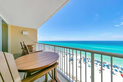 a balcony with a table and a view of the beach at Majestic Beach Towers 2-1005 in Panama City Beach
