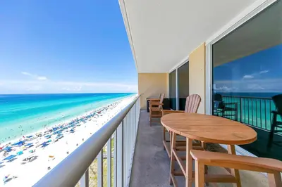a balcony with a table and chairs and the beach at Majestic Beach Towers 2-1005 in Panama City Beach