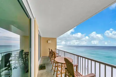 a balcony with a table and chairs and the ocean at Majestic Beach Towers 2-1005 in Panama City Beach