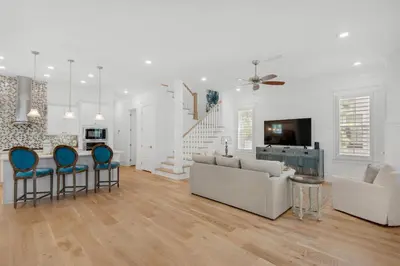 a white living room with a couch and chairs at Town of Prominence- Jetty's Hidden Jem in Inlet Beach