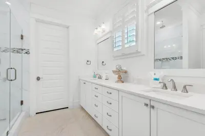 a white bathroom with a sink and a shower at Town of Prominence- Jetty's Hidden Jem in Inlet Beach