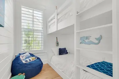 a white room with a bunk bed and a window at Town of Prominence- Jetty's Hidden Jem in Inlet Beach