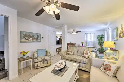 a living room with a couch and a ceiling fan at PCB Group Retreat with Deck, 1 Block to Beach! in Panama City Beach