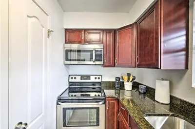 a kitchen with a stove and a microwave at PCB Group Retreat with Deck, 1 Block to Beach! in Panama City Beach