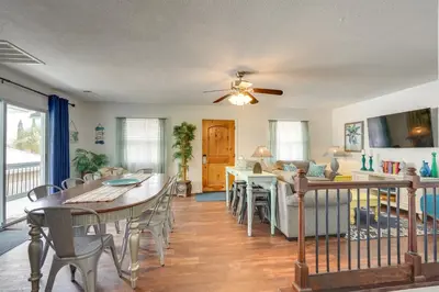 a dining room and living room with a table and chairs at PCB Group Retreat with Deck, 1 Block to Beach! in Panama City Beach