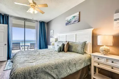 a bedroom with a bed and a ceiling fan at Majestic Beach Resort #204-2 by Book That Condo in Panama City Beach