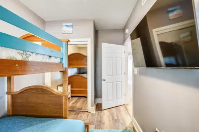 a room with two bunk beds and a door at Majestic Beach Resort #204-2 by Book That Condo in Panama City Beach
