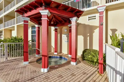 a pergola with a pool in the middle of a building at Majestic Beach Resort #204-2 by Book That Condo in Panama City Beach