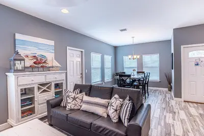 a living room with a couch and a table at Beach Daze in Panama City Beach