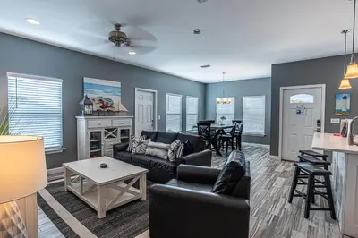 a living room with a couch and a table at Beach Daze in Panama City Beach