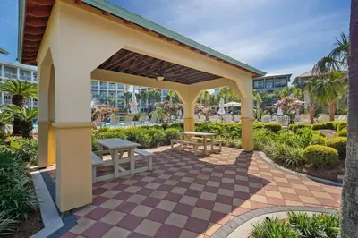 a pavilion with a picnic table and a bench at FantaSea in Panama City Beach