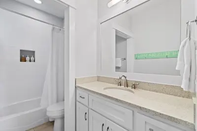 a white bathroom with a sink and a toilet at FantaSea in Panama City Beach