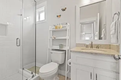 a bathroom with a shower and a toilet and a sink at FantaSea in Panama City Beach