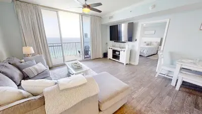 a living room with a couch and a table at Tidewater 1909 in Panama City Beach