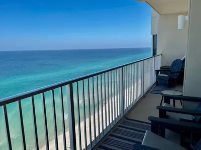 a balcony with chairs and a view of the ocean at Tidewater 1909 in Panama City Beach