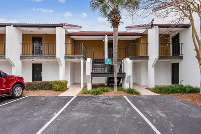 a parking lot in front of a building at Latitude Adjustment by Book That Condo in Panama City Beach
