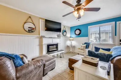 a living room with a couch and a fireplace at Gulf Highlands 170 by Book That Condo in Panama City Beach