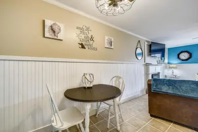 a dining room with a table and chairs and a kitchen at Gulf Highlands 170 by Book That Condo in Panama City Beach