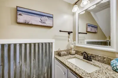 a bathroom with a sink and a mirror at Gulf Highlands 170 by Book That Condo in Panama City Beach