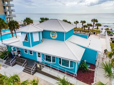 an aerial view of a blue house with the ocean in the background at Gulf Highlands 170 by Book That Condo in Panama City Beach