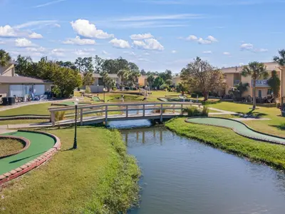a bridge over a river in a park at Gulf Highlands 170 by Book That Condo in Panama City Beach