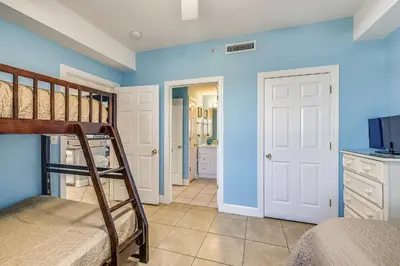 a bedroom with blue walls and a bunk bed at Twin Palms Resort 1604 by Book That Condo in Panama City Beach