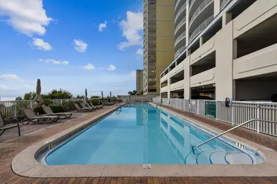 a large swimming pool with chairs and a building at Twin Palms Resort 1604 by Book That Condo in Panama City Beach