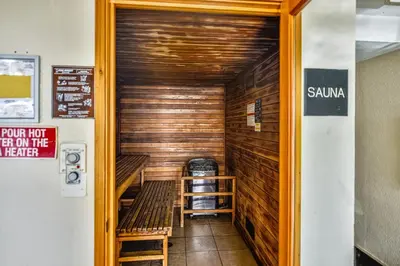 a sauna with a bench and a ladder in a room at Twin Palms Resort 1604 by Book That Condo in Panama City Beach