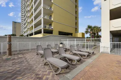 a row of chairs sitting in front of a building at Twin Palms Resort 1604 by Book That Condo in Panama City Beach
