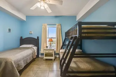 a bedroom with two bunk beds and a window at Twin Palms Resort 1604 by Book That Condo in Panama City Beach