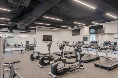 a gym with several treadmills and cardio machines at Modern Beach Vibe with a Breathtaking View - Stunning Pool - Pier Park in Panama City Beach