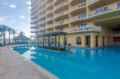 a swimming pool in front of a hotel at Modern Beach Vibe with a Breathtaking View - Stunning Pool - Pier Park in Panama City Beach