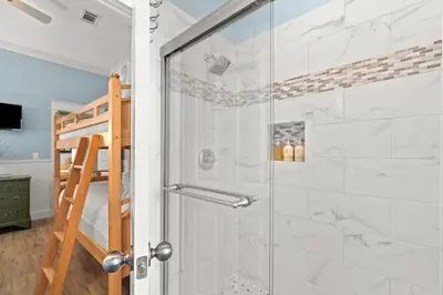 a shower with a glass door in a bathroom at Aquanut Beach House 30A in Inlet Beach
