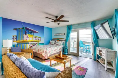 a living room with a bed and a couch at PCB Apt with Balcony and Gulf Views Walk to Beach in Panama City Beach